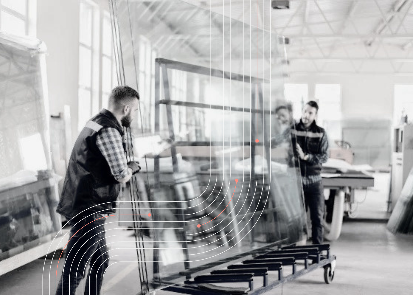 Workers handling large glass panels inside a manufacturing facility, representing glass production, supplier coordination, shipment visibility, and supply chain orchestration.